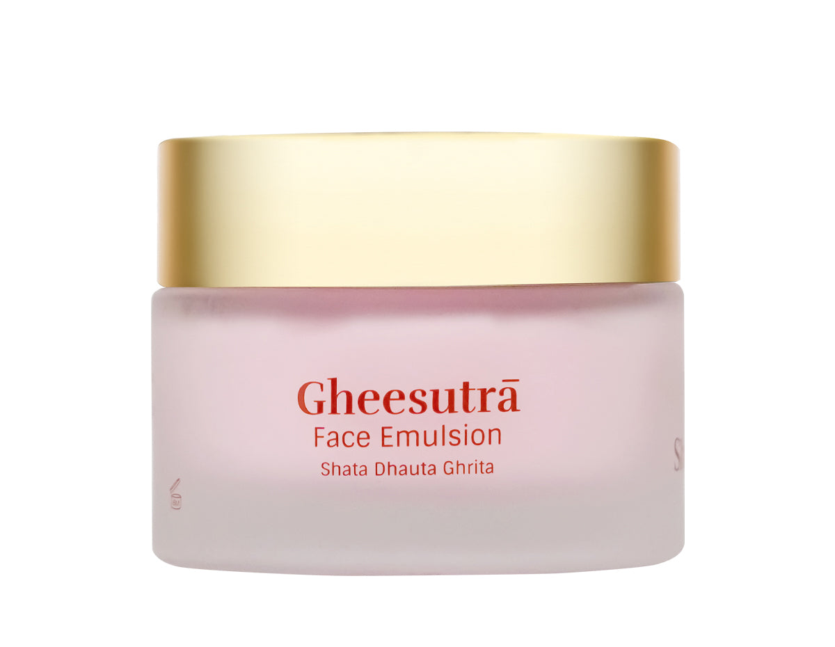 Gheesutra Face Emulsion in a frosted pale pink jar with a metallic gold lid, on a solid white background.